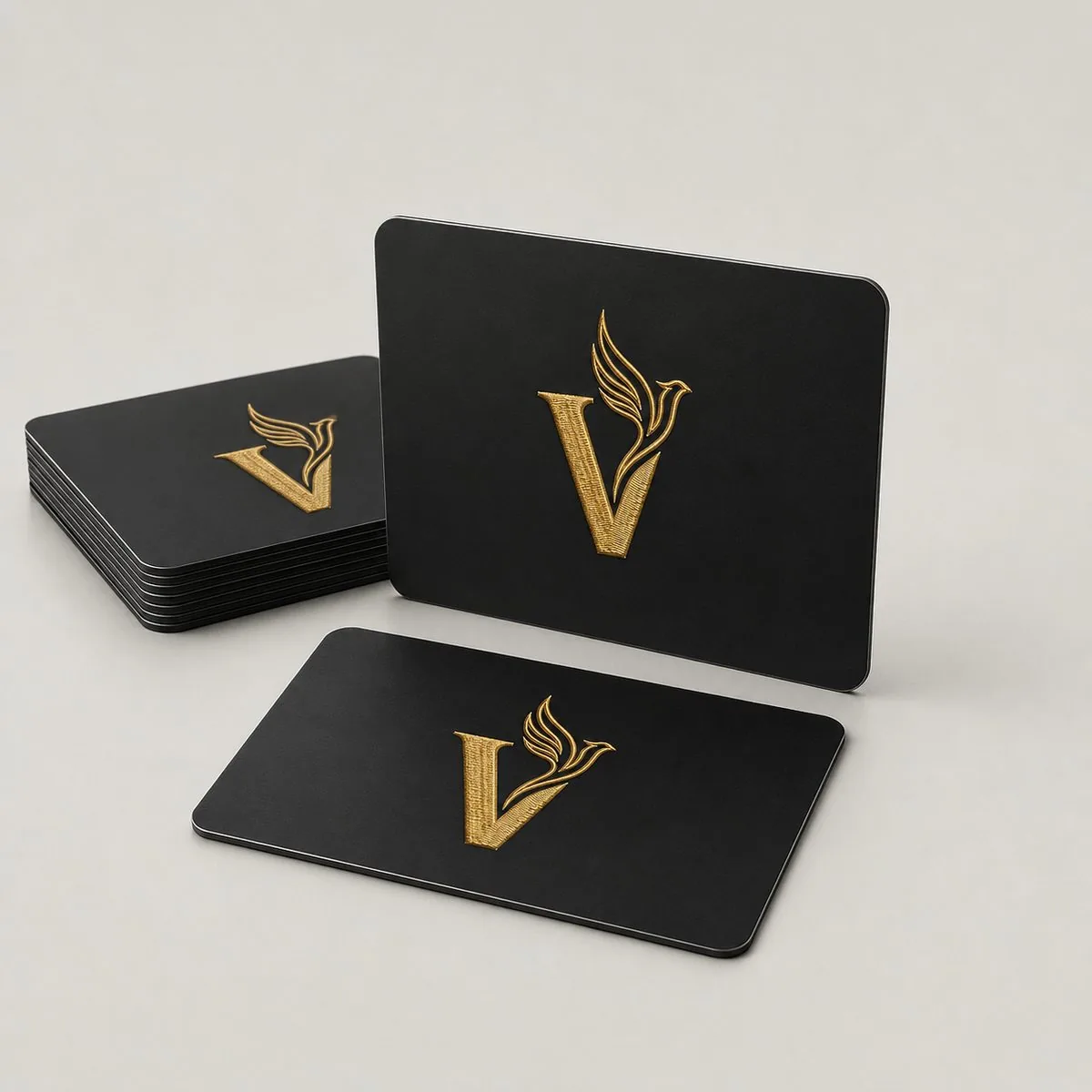 Custom laser engraved aluminum business cards with gold V Imprint Designs logo